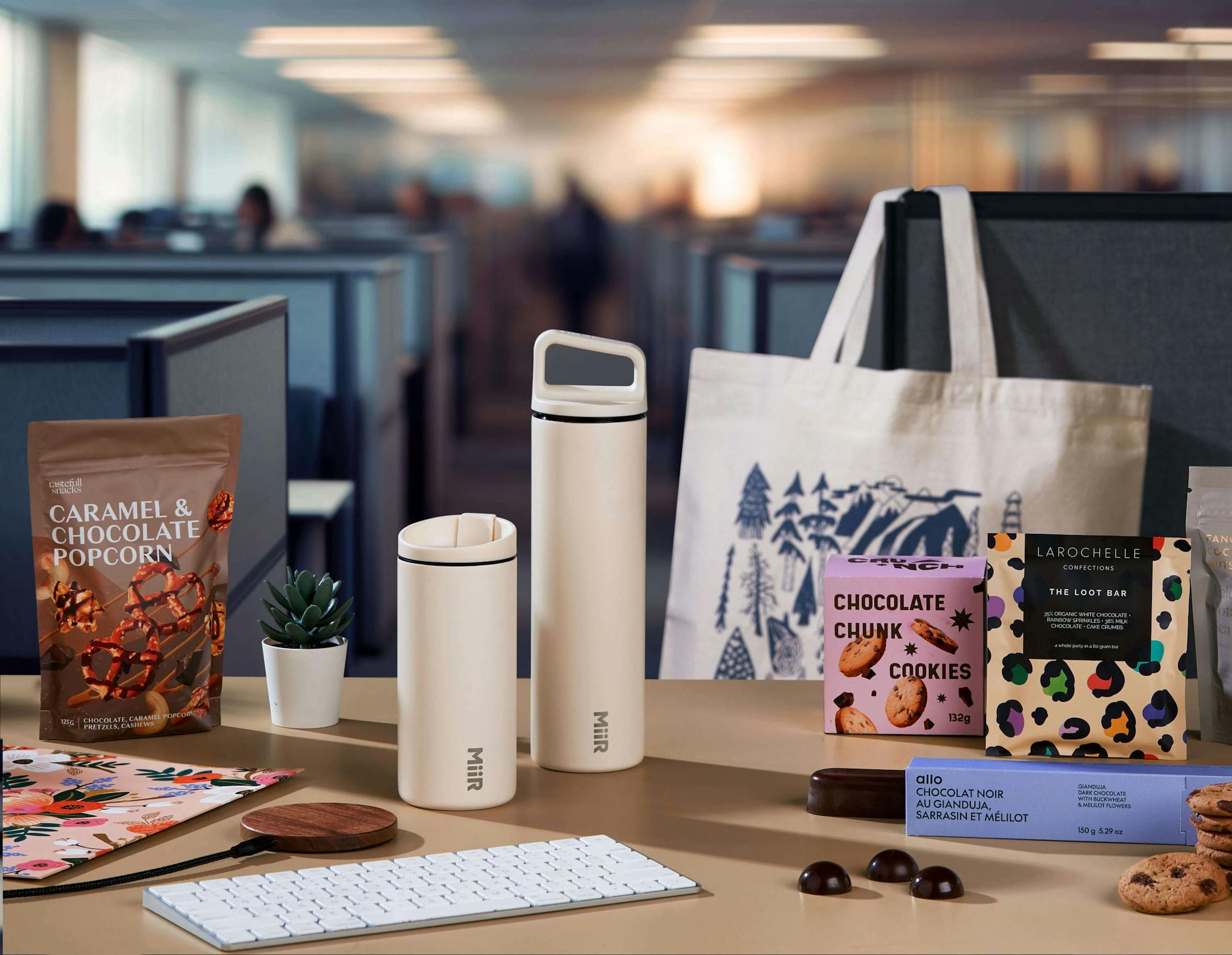 corporate gift ideas like swag and gourmet food products on desk in office