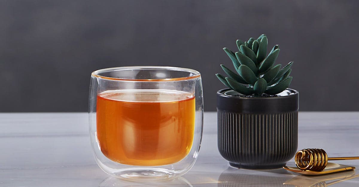 cup of tea and a plant on marble table